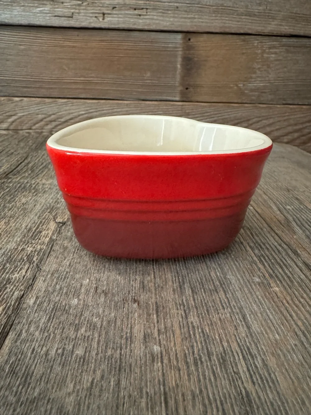 Red Le Creuset heart-shaped stoneware ramekin